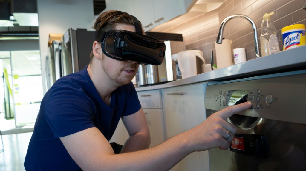 Image shows a man using VR to learn skills in fixing kitchen appliances - virtual vs vr training